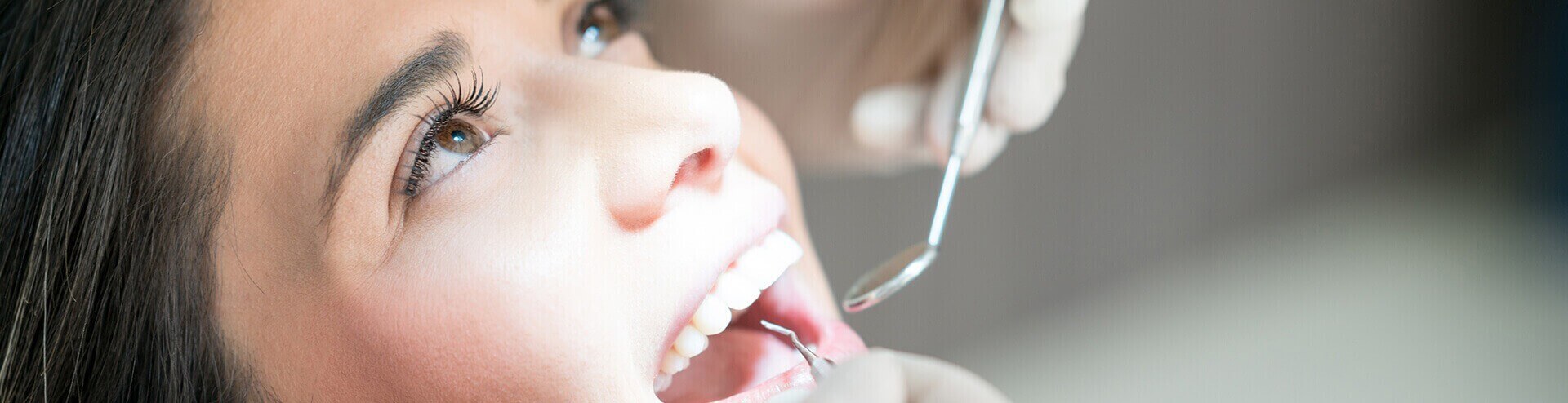 woman having her teeth examined by a dentist