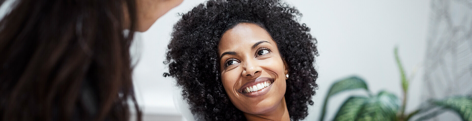 smiling woman speaking with her dentist