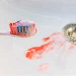 Blood on a toothbrush and in the sink as a warning sign of gum disease