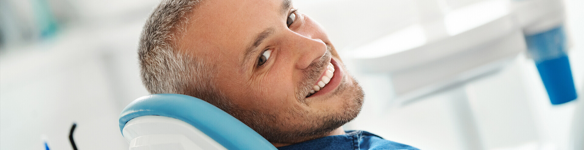 smiling man sitting in a dental chair