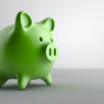 Green piggy bank on a gray background