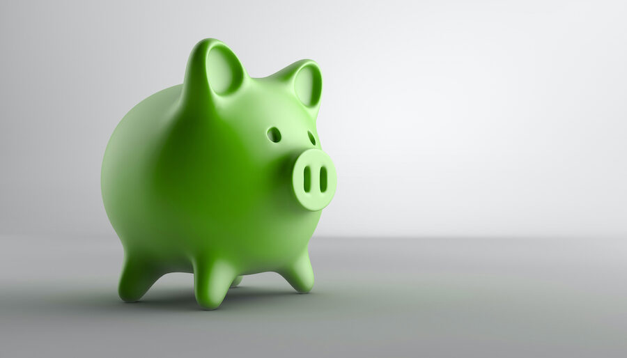 Green piggy bank on a gray background