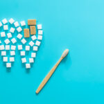 image of sugar cubes forming the shape of a tooth with cavities, dental plaque