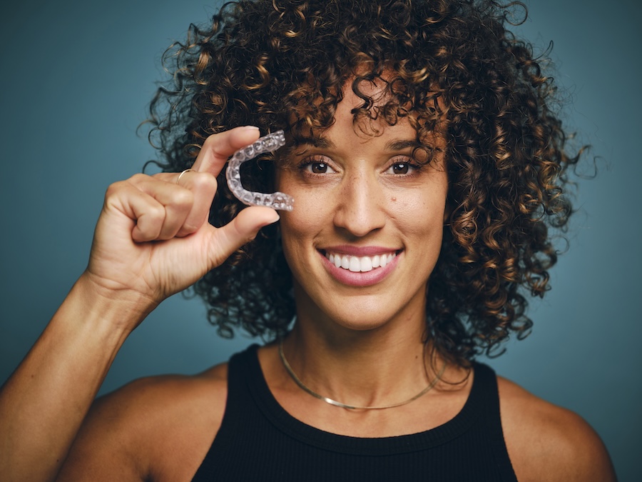 woman holding invisalign clear aligners after invisalign consultation