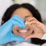 heart hands with dentist and patient, maximize dental benefits together