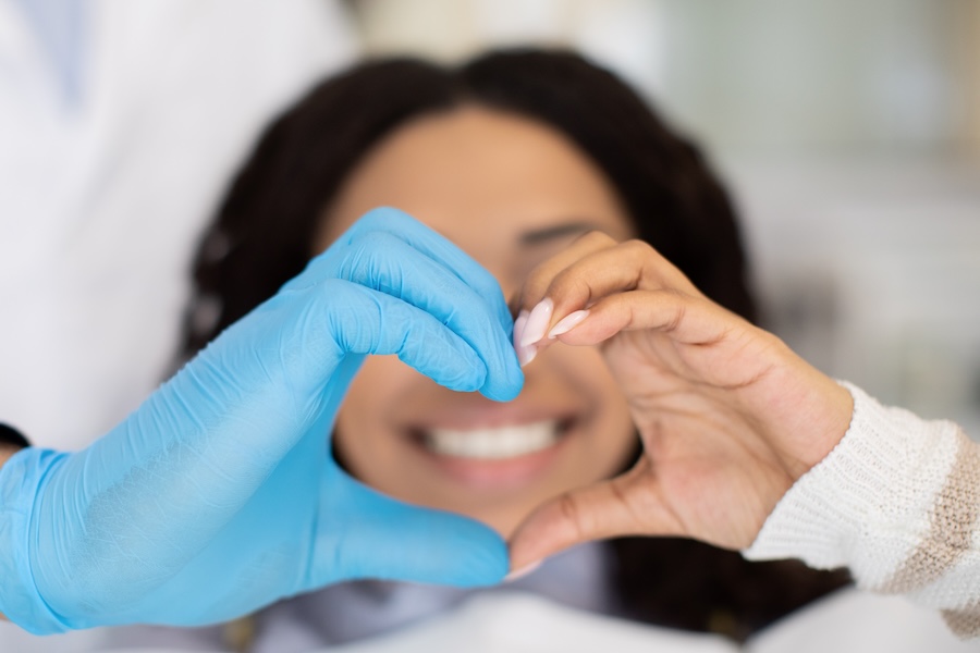 heart hands with dentist and patient, maximize dental benefits together